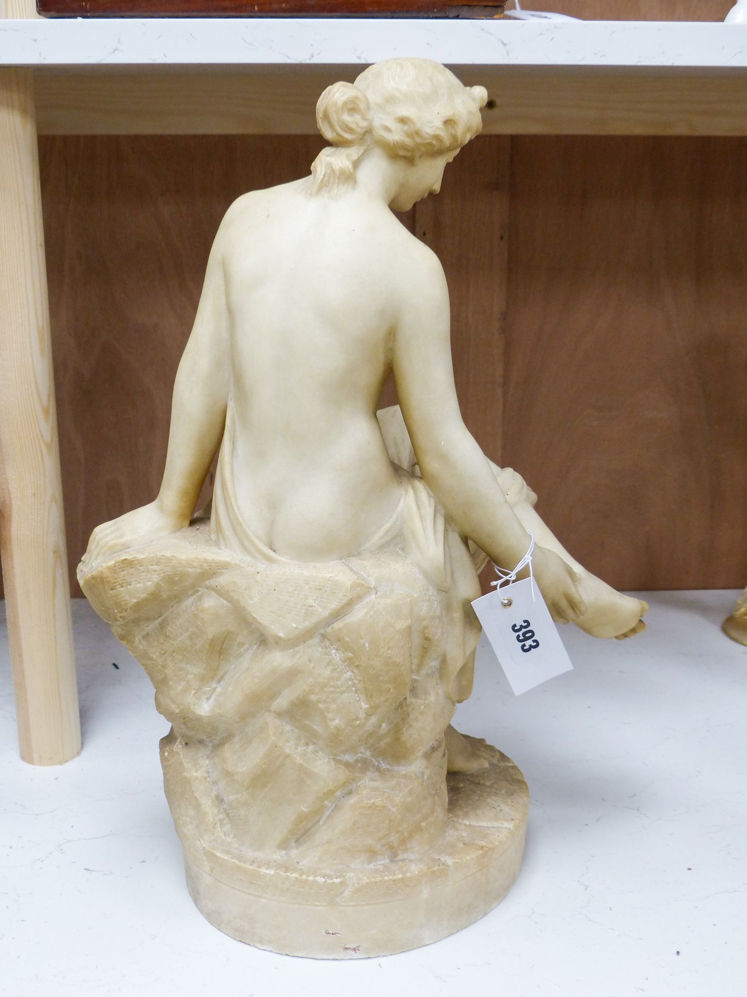 A 19th century Italian carved alabaster figure of a seated lady after the Antique, 45cm